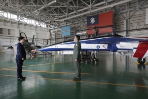 Taiwan's President Lai Ching-te listens to a briefing in an air hanger