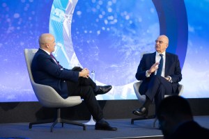 Endy Zemenides and Nikos Dendias on the Council's stage.