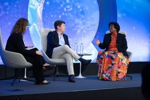 Rebecca Wolfe, Cameron Hudson, and Ertharin Cousin on stage at the Council.