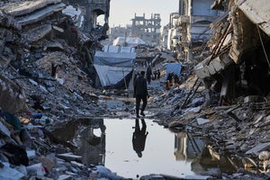 Palestinians walk amid the rubble of destroyed homes and buildings in Jabaliya, northern Gaza Strip