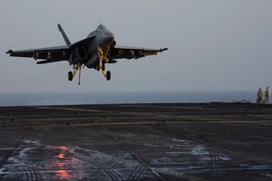 A fighter jet lands on the USS Dwight D. Eisenhower in the Red Sea 
