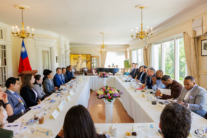 Members of the Emerging Leaders Program sit around a roundtable at Twin Oaks in Washington DC.