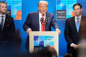 President Donald Trump speaks standing between Secretary of State Marco Rubio, right, and Defense Secretary Pete Hegseth during a press conference at the NATO Summit on June 25, 2025.