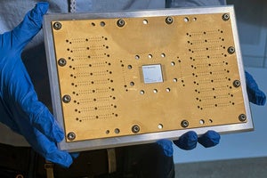 An IBM Heron quantum processor chip is in a circuit board at IBM headqauarters 
