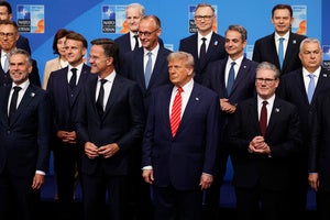 President Donald Trump poses during a group photo of NATO heads of state and government at the NATO summit in The Hague