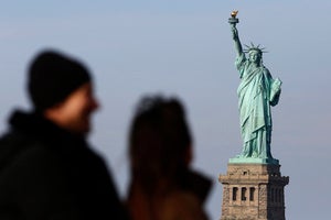 People view the Statue of Liberty in the distance