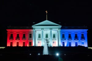 The White House is lit with the colors of the American flag