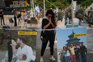 Ofir Kimchi prays as relatives and supporters of Israeli hostages held by Hamas celebrate news of a ceasefire deal at a plaza known as hostages square in Tel Aviv, Israel on October 9, 2025.