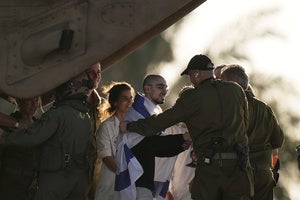 An Israeli hostage released from the Gaza Strip walks off a helicopter at the Sheba Medical Center in Ramat Gan, Israel
