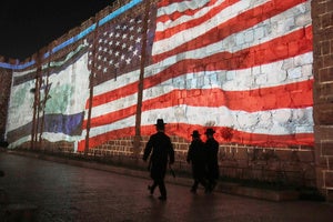 n Image of the US and Israeli flags is projected on the walls of Jerusalem's Old City