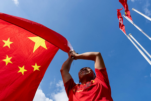 A man holds a Chinese national flag to mark the 76th National Day of the People's Republic of China in Hong Kong on October 1, 2025.