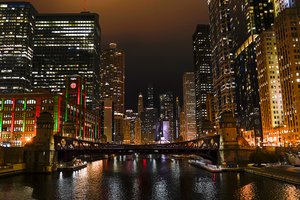 A photo of the Chicago river at night, looking east towards the skyline.