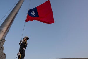 A guard adjusts a Taiwanese flag