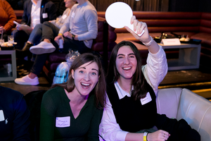 Two trivia bowl attendees smile for a photo.