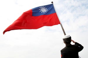 A Taiwanese military officer salutes to Taiwan's flag