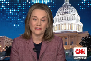Julianne Smith speaks in front of a background depicting the US Capitol building