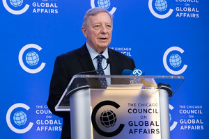 Senator Dick Durbin speaking at the podium during a press briefing at the Chicago Council on Global Affairs.