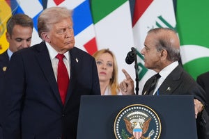  President Donald Trump listens as Pakistan's Prime Minister Shehbaz Sharif speaks at a podium