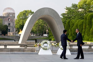 US President Barack Obama, right, shakes hands with Japanese Prime Minister Shinzo Abe at Hiroshima Peace Memorial Park in Hiroshima, western Japan, as Obama became the first sitting U.S. president to visit the site of the world's first atomic bomb attack.