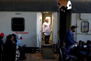 Person standing at the doorway of a mobile clinic