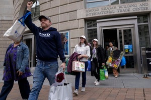 United States Agency for International Development (USAID) workers, carry their personal belongings after retrieving them from the USAID's headquarters in Washington, Thursday, Feb. 27, 2025