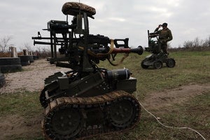 In this photo provided by Ukraine's 65th Mechanized Brigade press service, a soldier tests land drones in Zaporizhzhia region, Ukraine