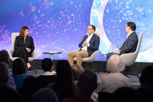 Three speakers on the Council's event stage.