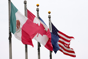 The flags of Mexico, Canada, and the United States fly next to each other.