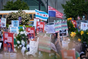 People hold signs and flags at a protest opposing "Operation Midway Blitz" and the presence of ICE, Tuesday, Sept. 9, 2025, in Chicago. 
