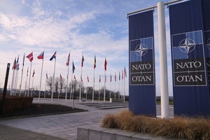 Flags flap in the wind outside NATO headquarters in Brussels