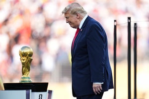 President DonaldTrump walks onto the stage for the trophy presentation during the World Cup final