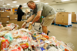 Volunteers sort through food donations at the St. Mary's Food Bank in Phoenix, AZ on June 29, 2022.