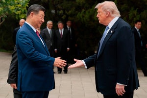 US President Donald Trump shakes hands with Chinese President Xi Jinping.