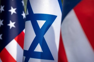 US and Israel flags stand outside of the White House