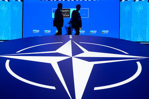 Two men walk past the NATO logo during the NATO summit in Ankara, Turkey, on July 7, 2026.