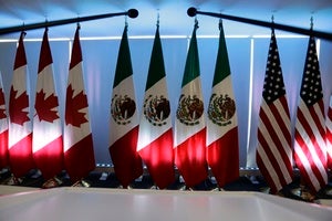 National flags representing Canada, Mexico, and the U.S. are lit by stage lights at the North American Free Trade Agreement, NAFTA, renegotiations, in Mexico City, Tuesday, Sept. 5, 2017.