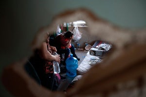 A Central American migrant woman cries in frustration before being removed by police from a house controlled by human smugglers, to transfer her and other occupants to a government shelter from which they will be returned to their native country, in Ciudad Juarez, Mexico, Saturday, July 3, 2021. 