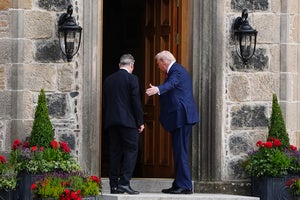 U.S. President Donald Trump, right, and British Prime Minister Keir Starmer walk at Trump International Golf Links in Aberdeenshire, Scotland, Monday, July 28, 2025. 
