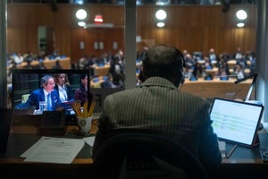 A screen shows Rafael Grossi, left, International Atomic Energy Agency (IAEA) Director General and a candidate for United Nations Secretary-General, speaking during an informal dialogue at U.N. headquarters, Tuesday, April 21, 2026. 
