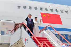 In this photo provided by the North Korean government, Chinese President Xi Jinping, left, and his wife Peng Liyuan arrive at the airport in Pyongyang, Monday, June 8, 2026.
