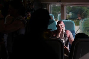 A man on a train wipes sweat from his face on a hot day in London, Wednesday, June 24, 2026.