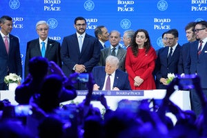  President Donald Trump signs the charter of his Board of Peace initiative at the Annual Meeting of the World Economic Forum in Davos, Switzerland, Jan. 22, 2026. 