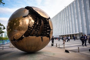 People walk around the plaza by the Sphere Within Sphere outside the United Nations Headquarters on the first day of the 80th session of the UN General Assembly's High-Level week, Monday, Sept. 22, 2025. 
