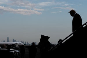 President Donald Trump disembarks Air Force One at Newark Liberty International Airport, New York seen in the background, Friday, Aug. 7, 2026, in Newark, N.J. 