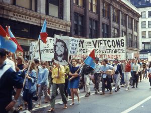 Protestors walk through downtown Chicago carrying signs