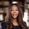 Headshot of Dambisa Moyo standing in a black outfit.