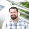 Council expert AJ Caughey is pictured outside in a plaid shirt looking into the camera smiling