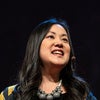 Angel Hsu speaking in front of a black background