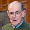 John Mearsheimer headshot; photograph of older man with glasses wearing a green sweater