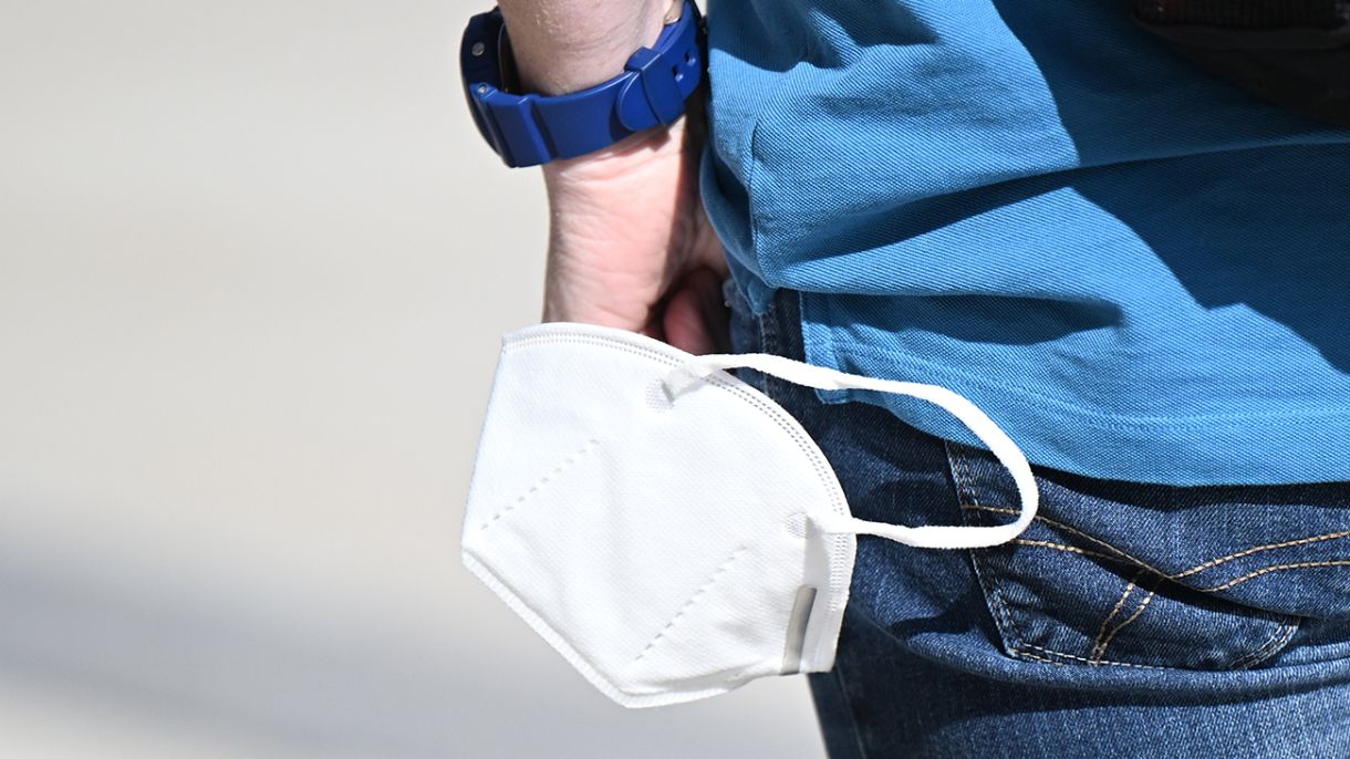 a person wears a mask on their wrist